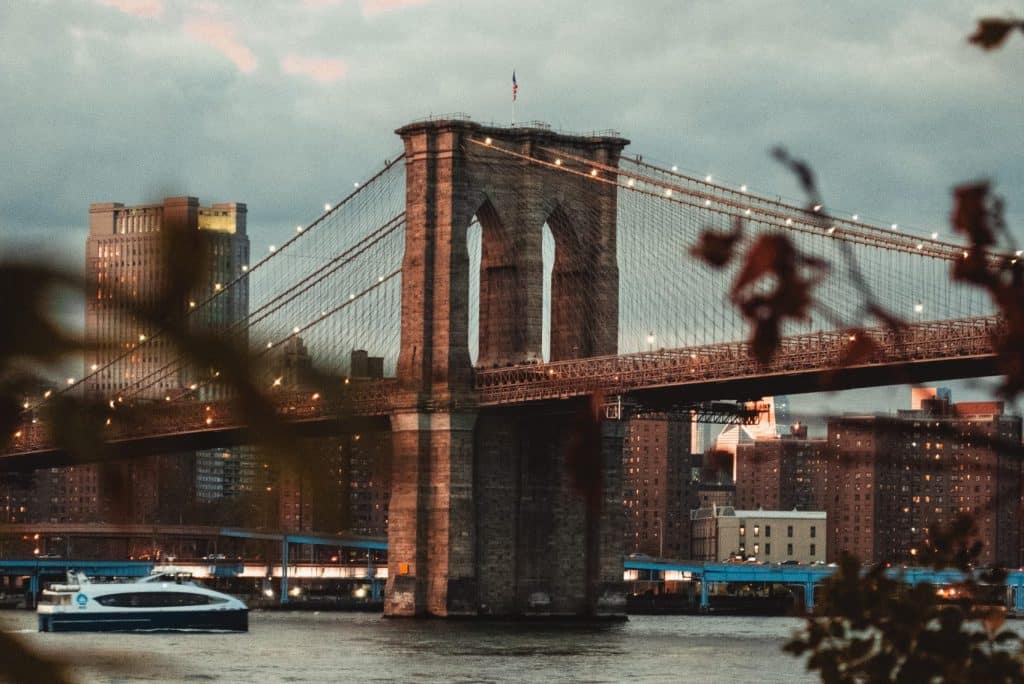 Il Ponte di Brooklyn al tramonto visto dalla sponda di Dumbo fra i rami